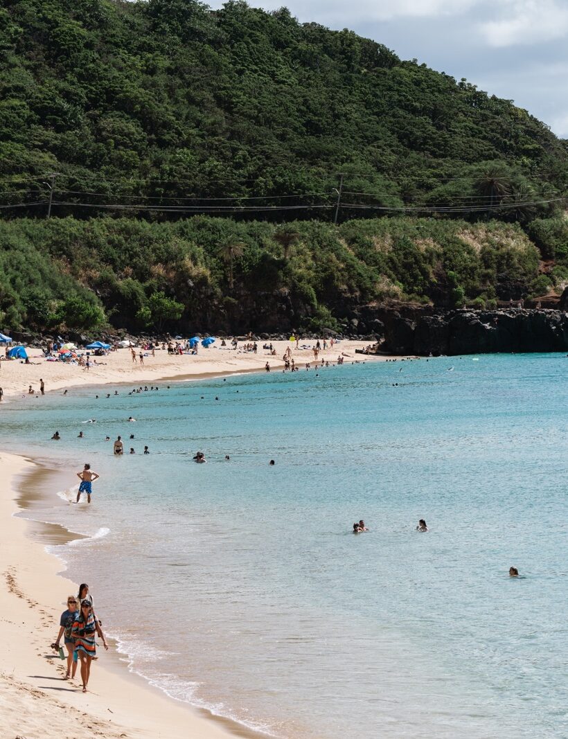 Waimea Bay beach full of swimmers on the North Shore of Oahu